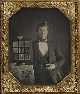 Restored portrait of a Daguerreotypist displaying daguerreotypes and cases