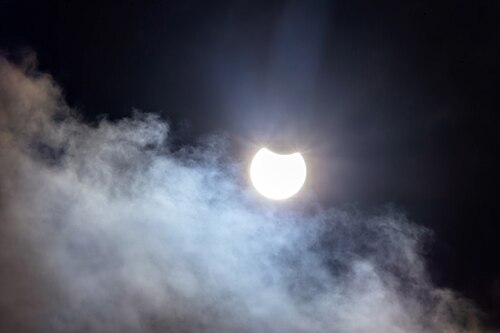 Partial solar eclipse with some clouds in Tuntorp, Sweden.