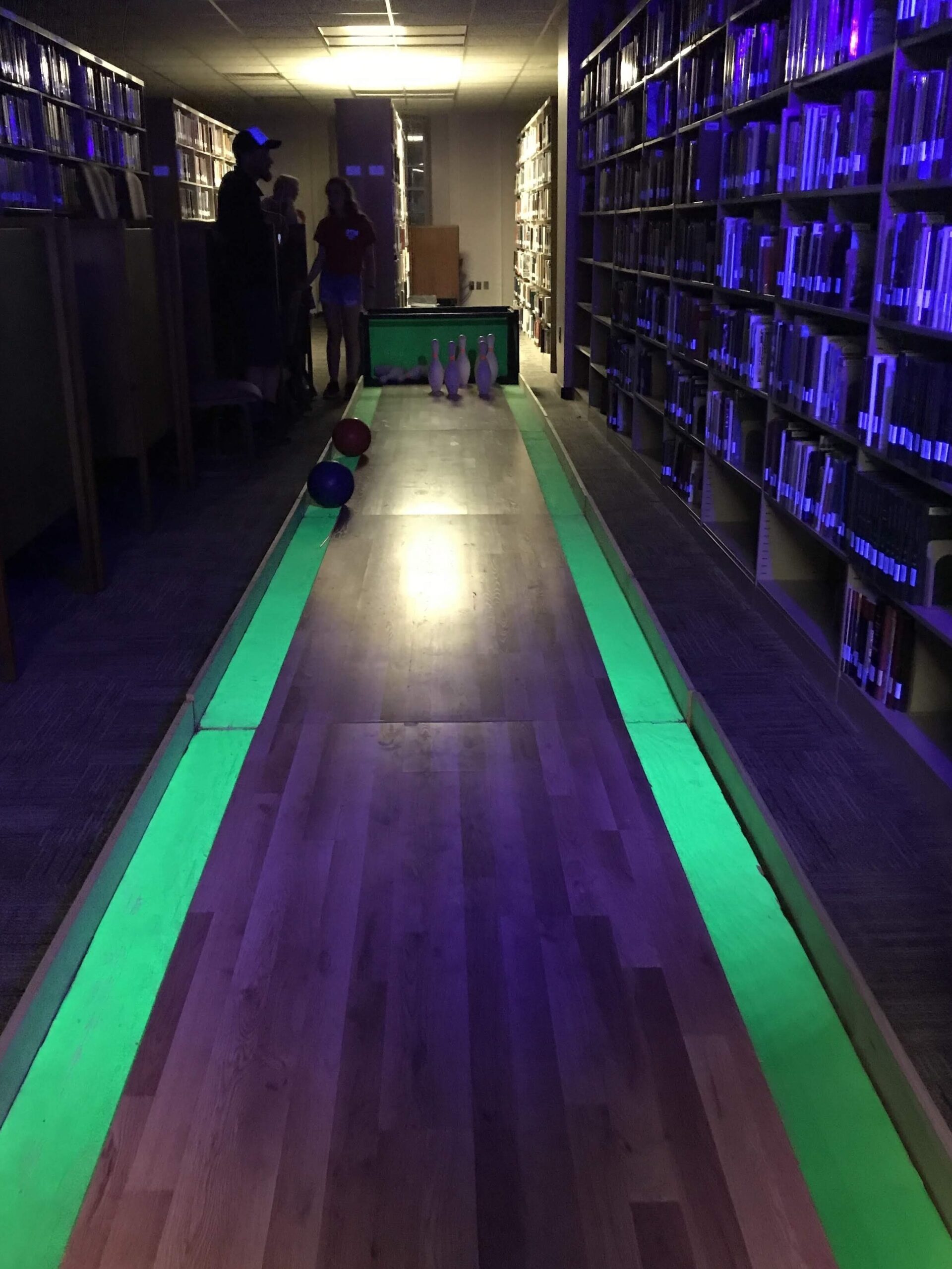 Glow in dark bowling in the stacks.