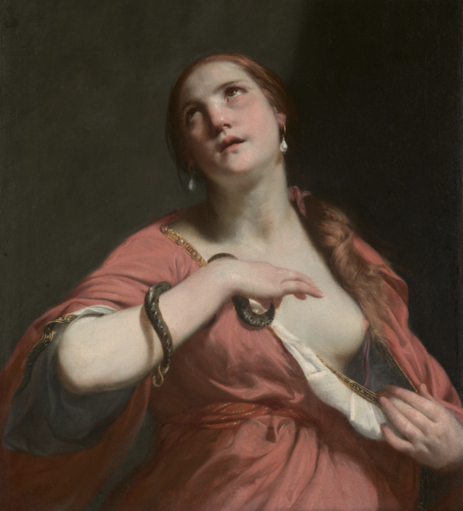 Cleopatra pulling down her dress top to reveal her left breast for the snake to bite and kill her