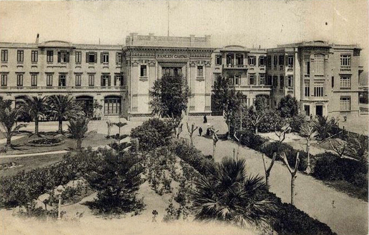 Photo of the San Stefano Hotel and Casino with the tree and plant lined path leading up to the entrance.