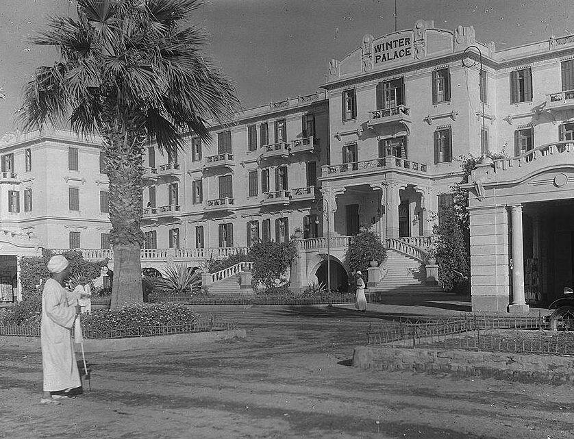The Winter Palace in Luxor with a man standing in front of the entrance