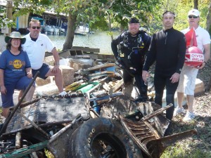 Five volunteers with debris from clean up day.