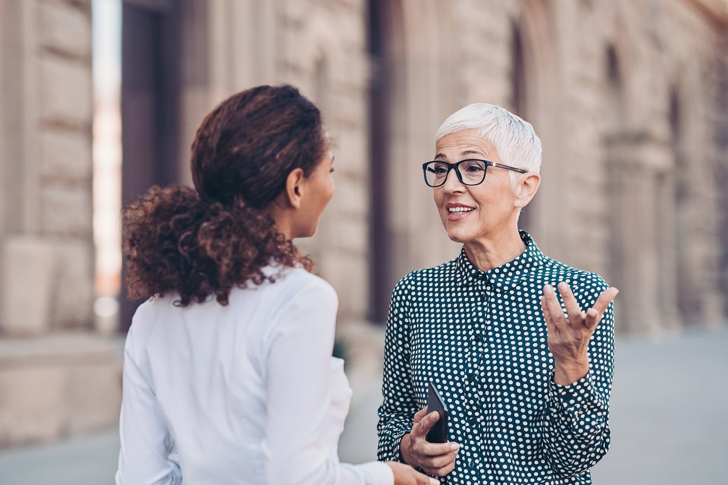 two people talking stock image.