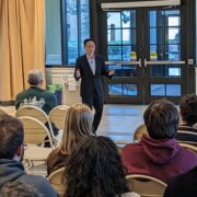 Speaker talking to audience at Davidson College Lilly Gallery.