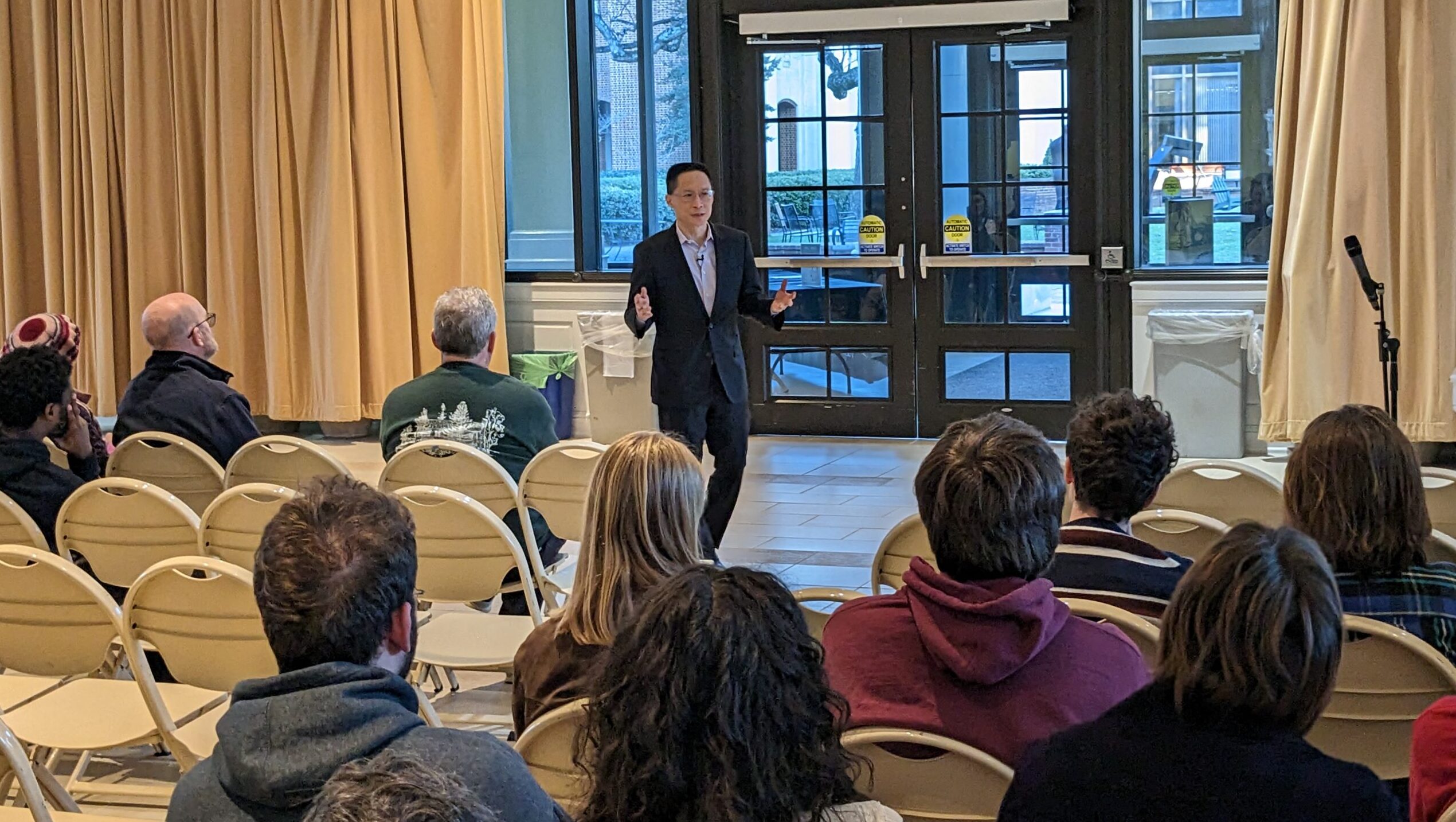 Speaker talking to audience at Davidson College Lilly Gallery.