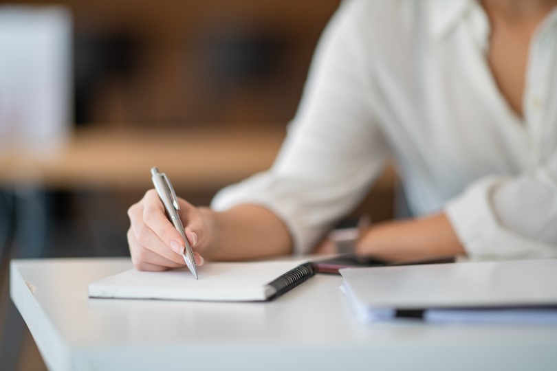 Stock Image of Person notetaking