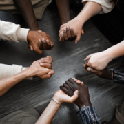 People of different races holding hands in a circle
