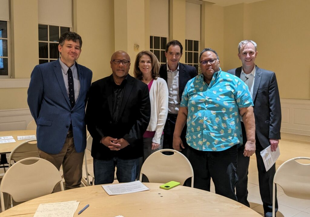 Photo of panelists and organizers standing together.