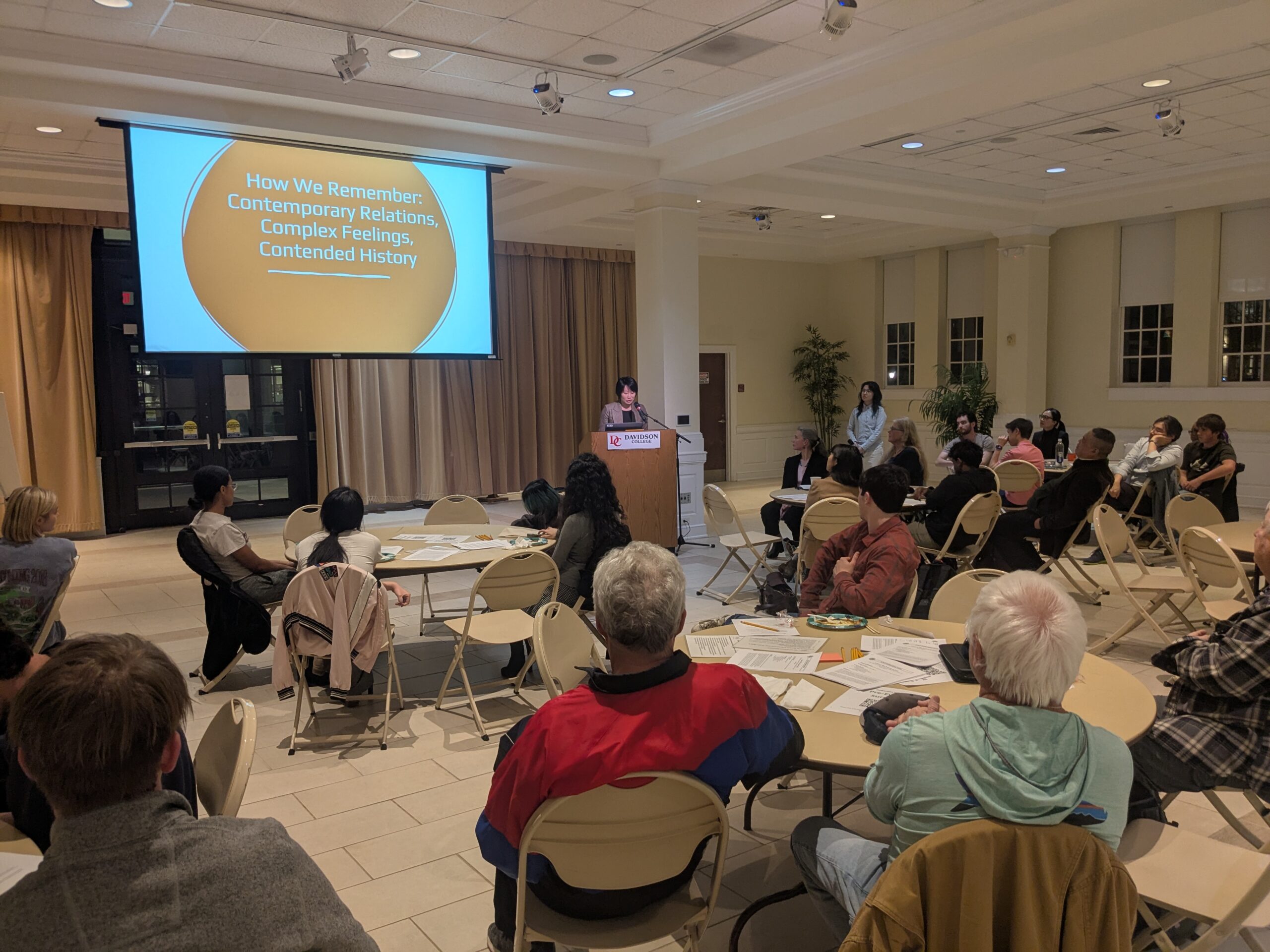 photo of deliberative event with screen in the background