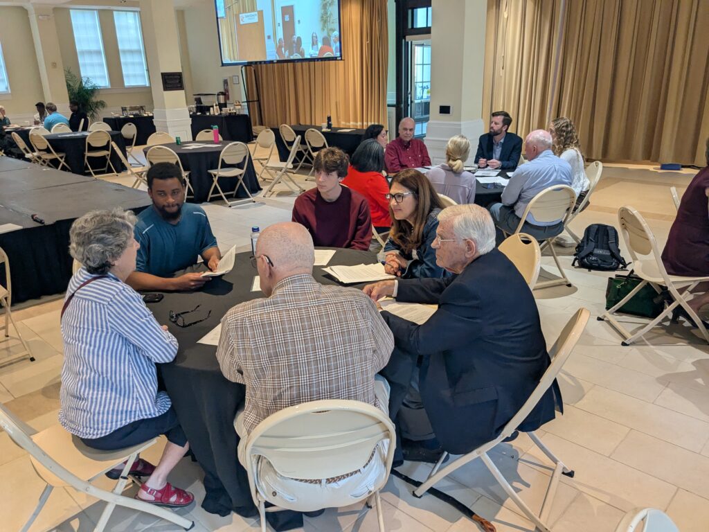 deliberators sitting around tables.