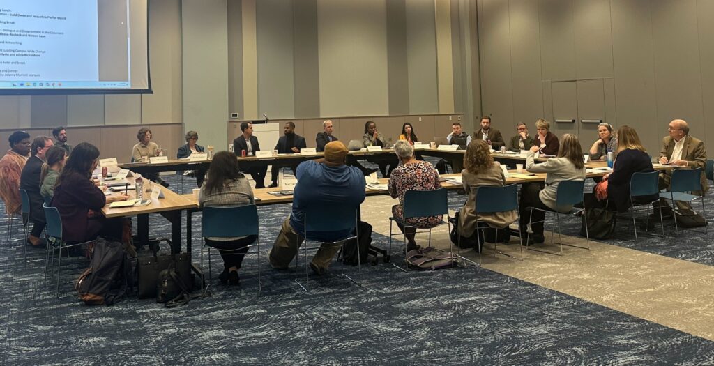 Wide angle view of conference attendees at main table