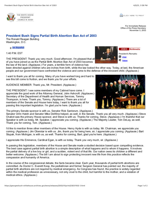 There are two photos on this website page. The first is a photo of Bush signing the bill into law on a desk. The second is Bush signing the bill, sitting at a desk, surrounded by various men who are supporting the bill.