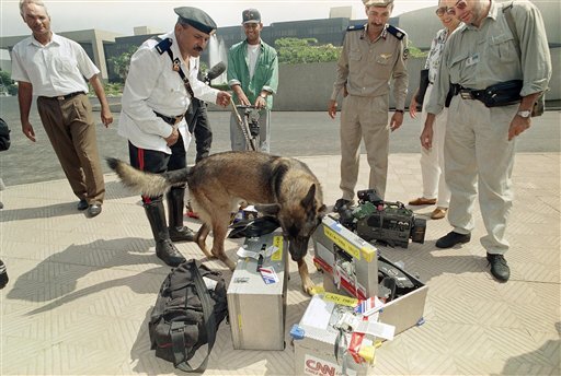 PA bomb-sniffing dog examines TV equipment belonging to Cable News Network at the entrance to the Cairo conference grounds in Cairo, Egypt on Friday, Sept. 2, 1994 where the UN population conference will take place next week.