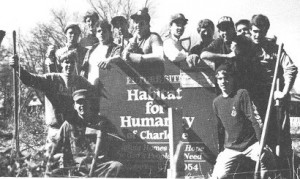 Kappa Sigma members standing around sign