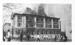 watts dormitory building burning while students casually walk by