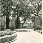 Entrance gates to the Carnegie Library (now Carnegie Guest House) with two black balls on top of the pillars, one of them painted to look like an 8-ball. 