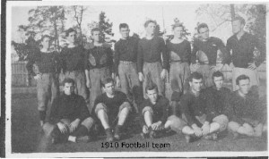 the 1910 football team, 14 members, two trees in the background