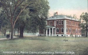 Postcard of Martin Chemical Building, 1907. Featuring trees and two people walking under them on a path.