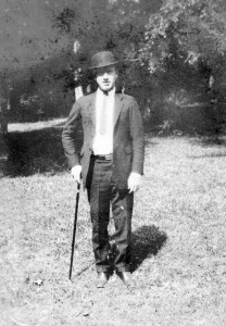 Student with derby and cane