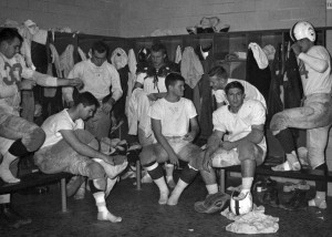 Players putting on their equipment in the locker room