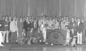 reunion photo of the class of 1953 holding a flag with the Davidson college seal and year