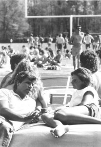 Students frolicing on and around the football field in 1984