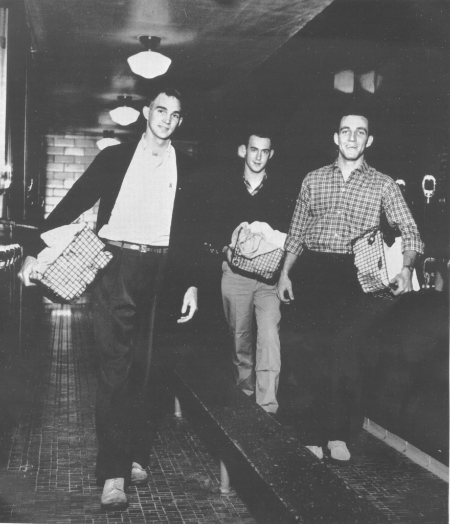 Students (including future College President John W. Kuykendall, at rear) carry their "bundles" to the Laundry, 1957.