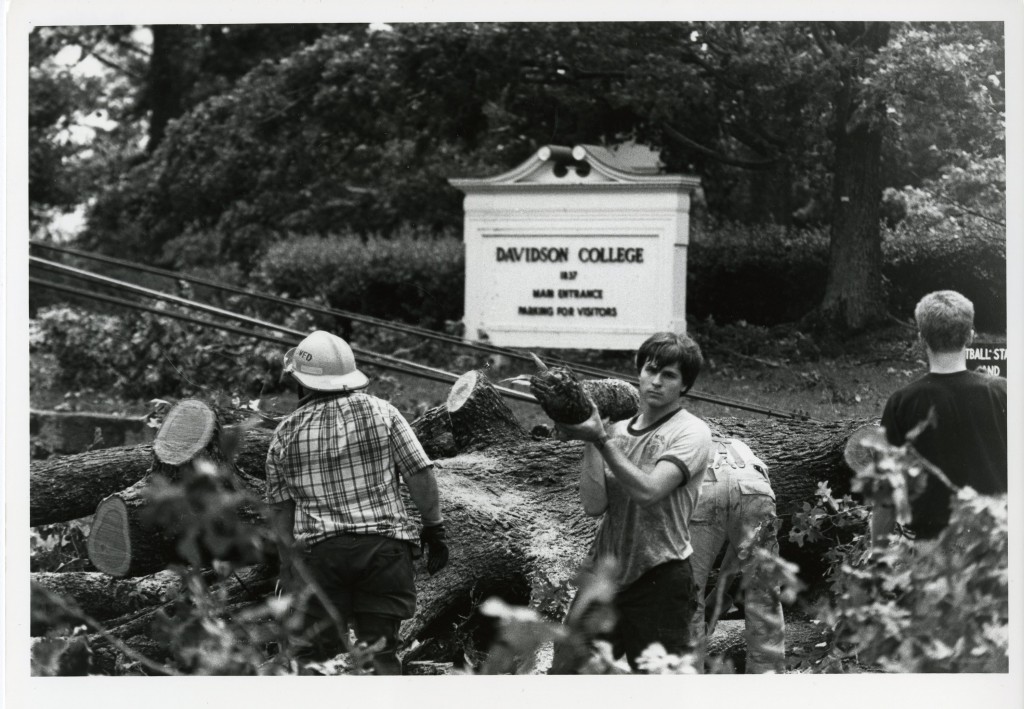 Freshman Jay Spiegel helping clear downed trees near the main entrance to the college.