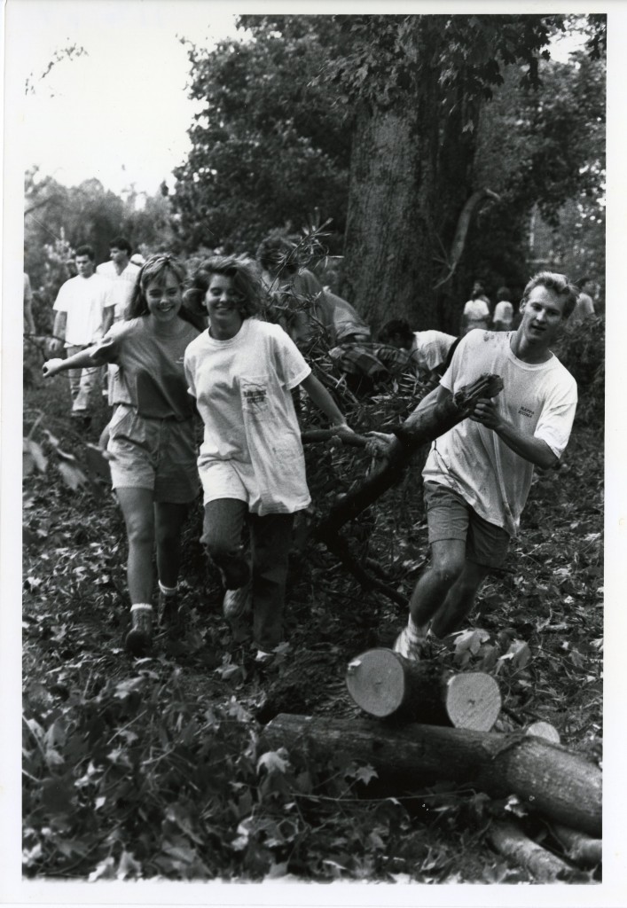 Hilary Coman, Hilary Bridgers, and Blaine John (all Class of 1992), spending their day off from classes helping clean the campus by dragging broken branches