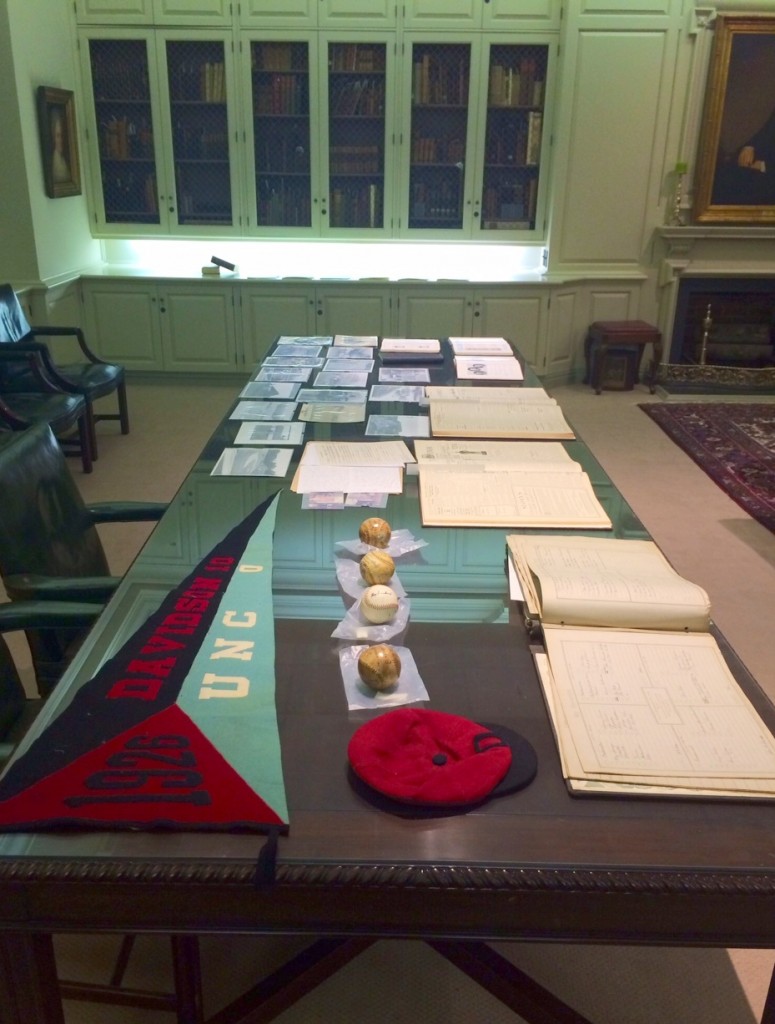 The display Sharon and I set up for a donor visit - we pulled collections and objects to highlight the donors' father (an alumnus), as well as the athletic history of Davidson. There is a football pennant from 1926 showing the score of the game against UNC, Davidson 10 UNC 0. A beanie, 4 baseballs, and other documents.