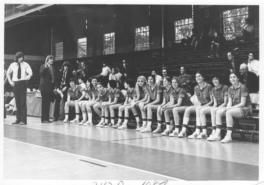 The women's basketball team on the bench during a game in Johnston Gym, circa late 1970s.