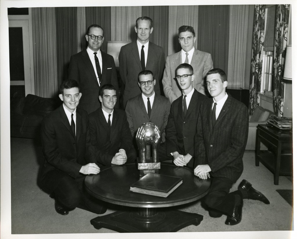 We're not sure what the award on the table is, but it's being presented by then College President D. Grier Martin (standing, center) and Professor of Spanish James Young Causey (standing, right).