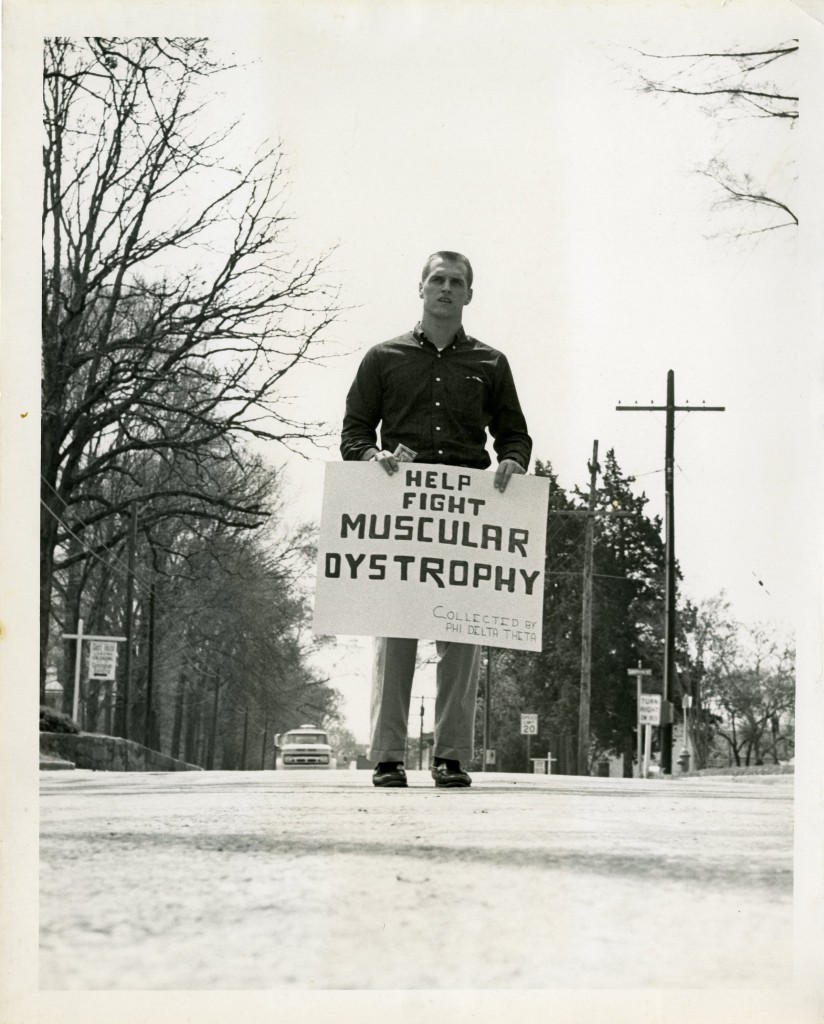 Alex Gibbs (Class of 1963) raises money for muscular dystrophy on behalf Phi Delta Theta in the middle of Main Street. Gibbs went on to a long football coaching career, most notably for the Denver Broncos. 