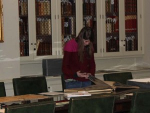 2015 student in the rare book room with scrapbooks from the year 1925