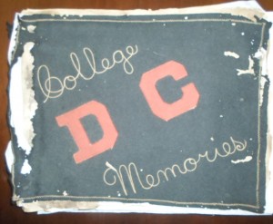 Cover of Roy Perry's scrapbook. The cover says, "College D C Memories" with "D C" in red and "College Memories" in tan with a black background. He was a member of the class of 1916.