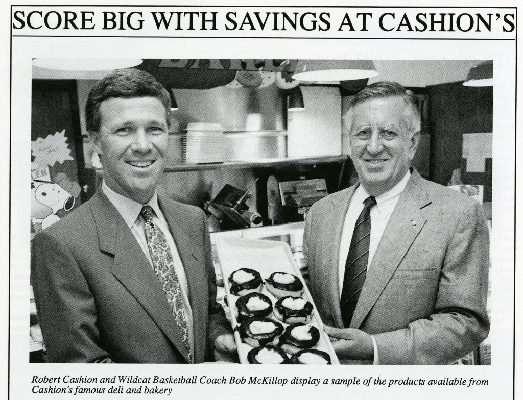 McKillop posing for a photo with Robert Cashion of Cashion's deli, for the 1991 - 1992 media guide.