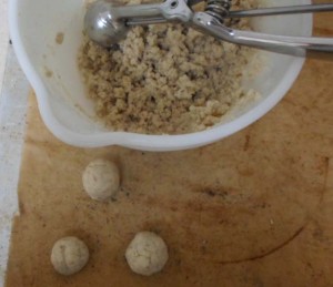 Forming the cookies using a cookie scoop, a picture of a bowl of cookie dough with 3 balls already made with the cookie scoop