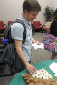 Poet Scott Cunningham volunteers to be the first to try the cookies.