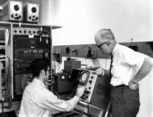 Physics professor Locke White helps a student stay plugged in 1960s-style.