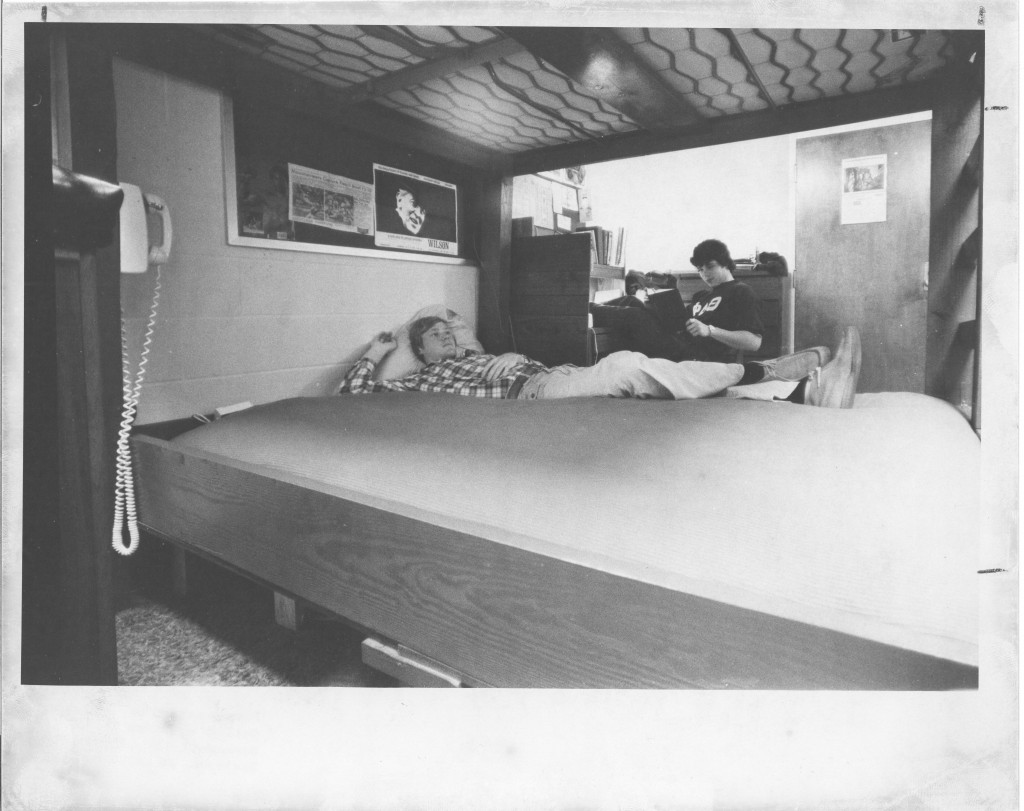 Two roommates spend time in their somewhat sparsely decorated dorm room in 1977 (photograph taken by Bill Giduz, Class of 1974). Notice the cameo appearance of Davidson attendee Woodrow Wilson on the wall above the bottom bunk.