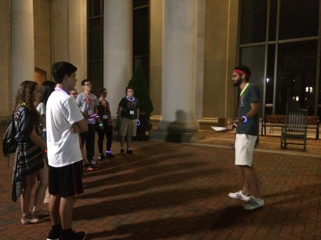 Orientation Leader Santiago Navia (Class of 2017) tells a group of new internationals students the tale of Bill Edwards in front of E.H. Little Library.