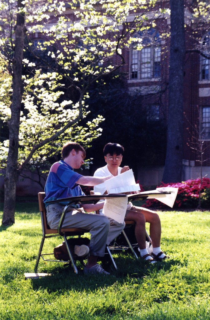 Jin Hyuk Chang and Theodore Edward Curey (both Class of 1996) study at desks outside, 1996.