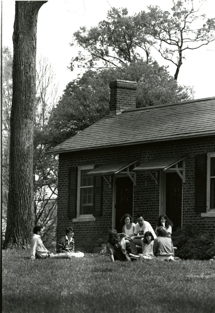 A group of students gather outside in front of Elm Row, possibly for a class meeting.