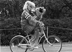 1984 Wildcat Mascot with a #49 football jersey riding a bicycle