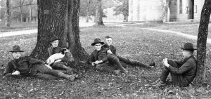 Student Army Training Corps members laying down next to a tree