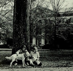 1976 yearbook photo of two people sitting next to a tree with a dog