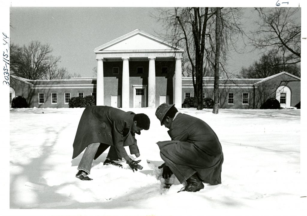 Two students play in the snow in front of Cunningham, circa 1975.