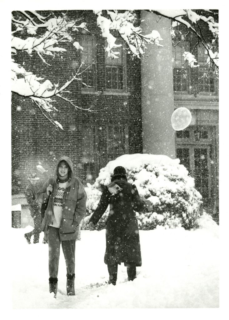 Two students walk near Chambers in the snow, 1987.