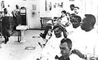 A day in Ralph Johnson's barbershop. Three men getting their hair cut.